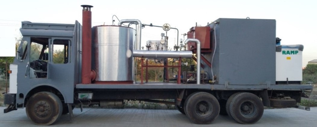 Industrial mobile steam generator unit with control panel and safety valves, mounted on wheels for portability